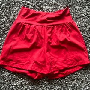 Bright red athletic shorts with liner. Size large never worn. Longer inseam